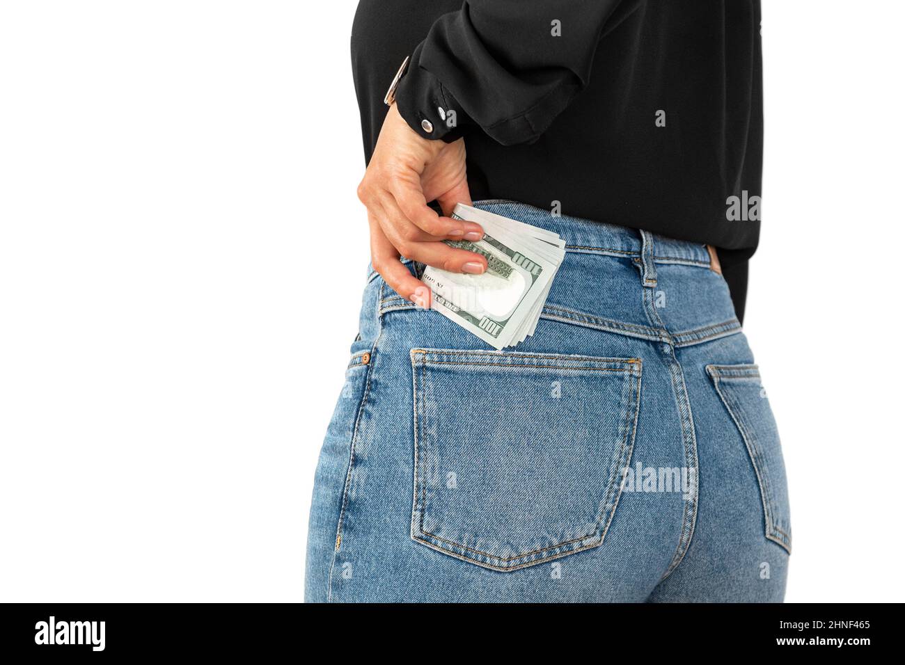 Woman putting money in her back pocket. one hundred american dollars bill Stock Photo