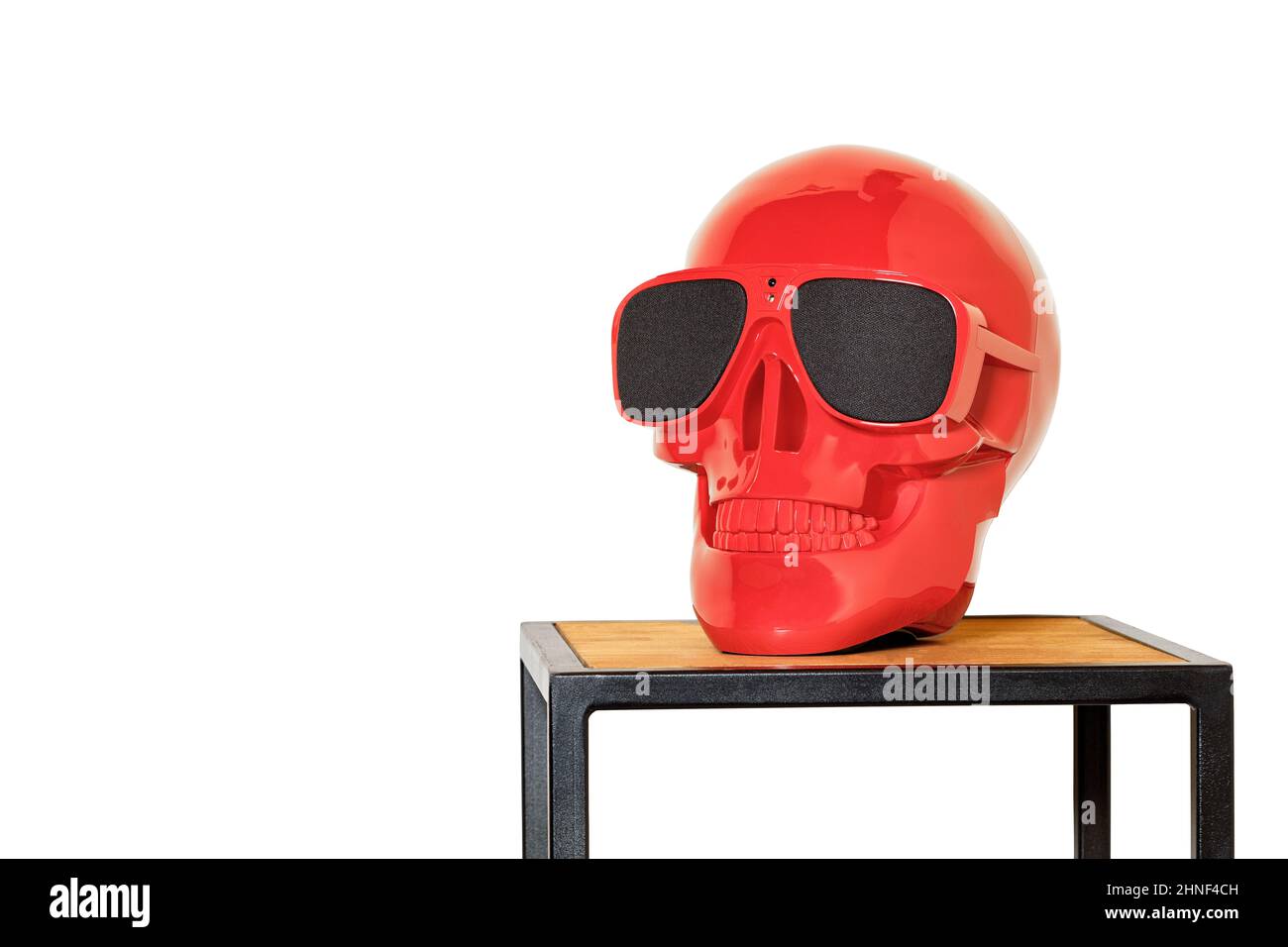 Red colored human skull mockup on coffee table in loft style isolated on white background. Stock Photo