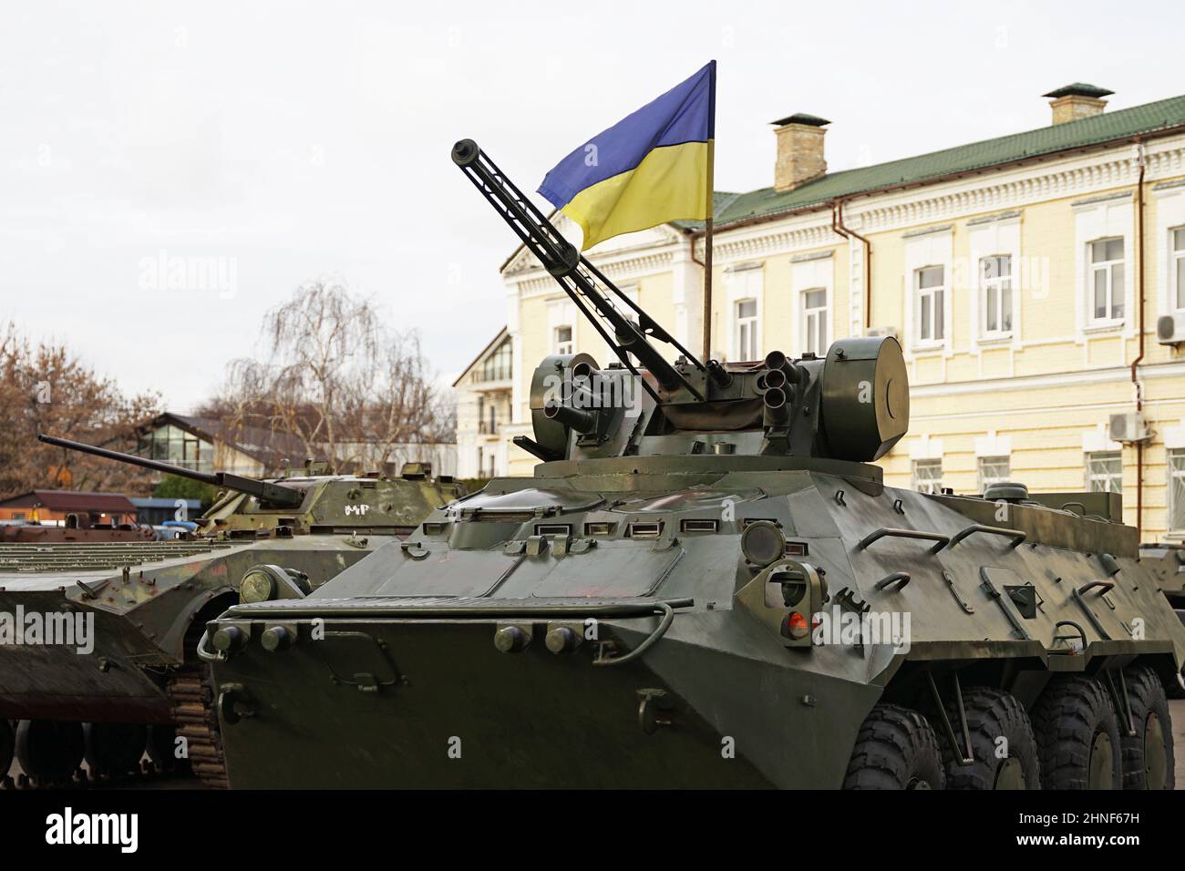 Army troops transporter and tank with Ukrainian flag, Ukraine - Russia war crisis concept, Kyiv Stock Photo