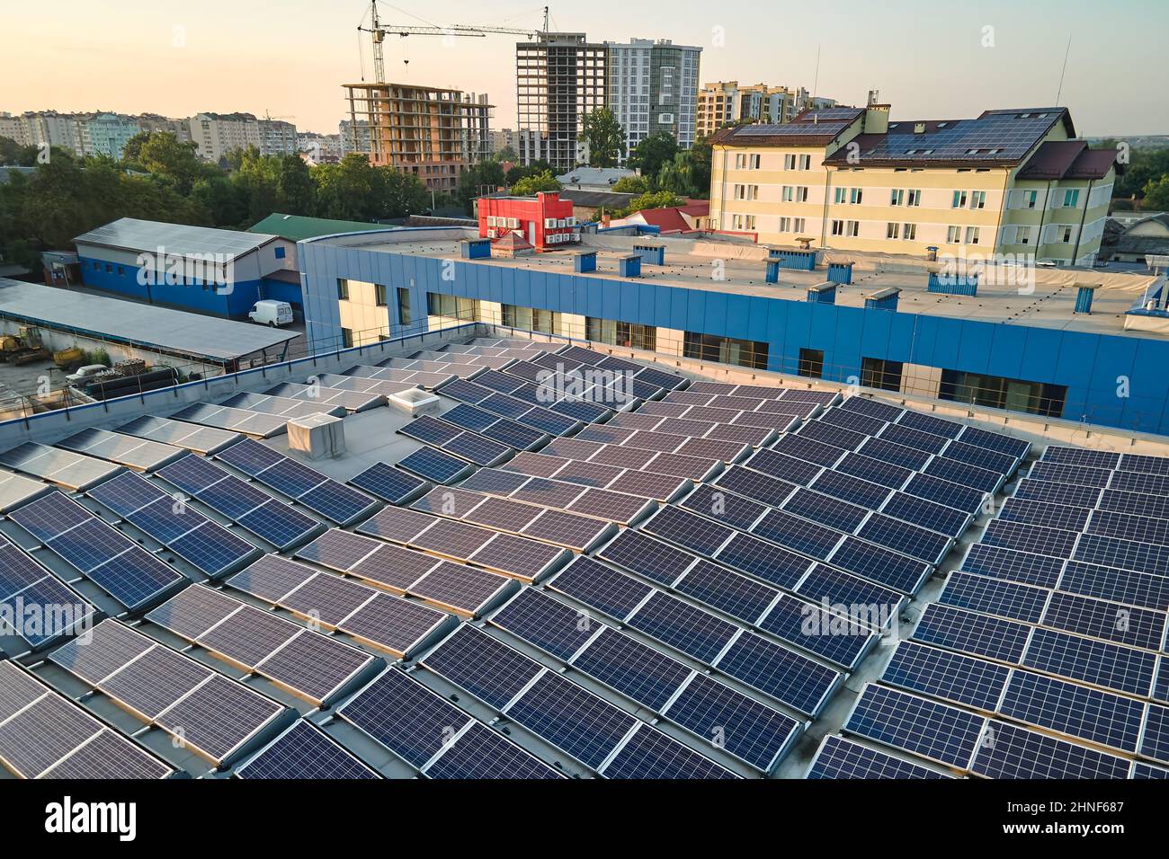 Aerial view of blue photovoltaic solar panels mounted on industrial ...