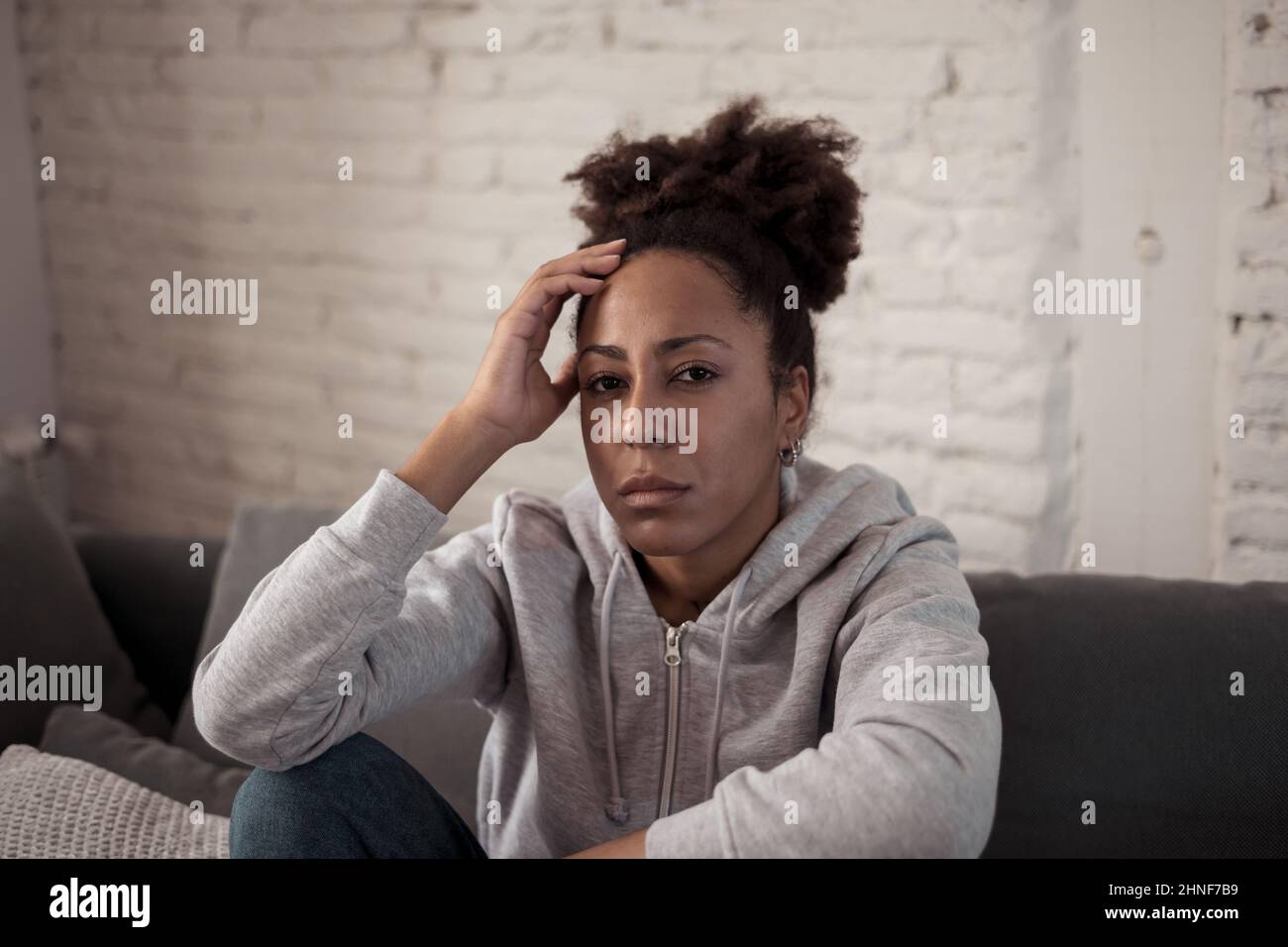 Young devastated depressed African American woman crying feeling sad, hurt suffering depression sadness and emotional pain. Mental health in young Stock Photo
