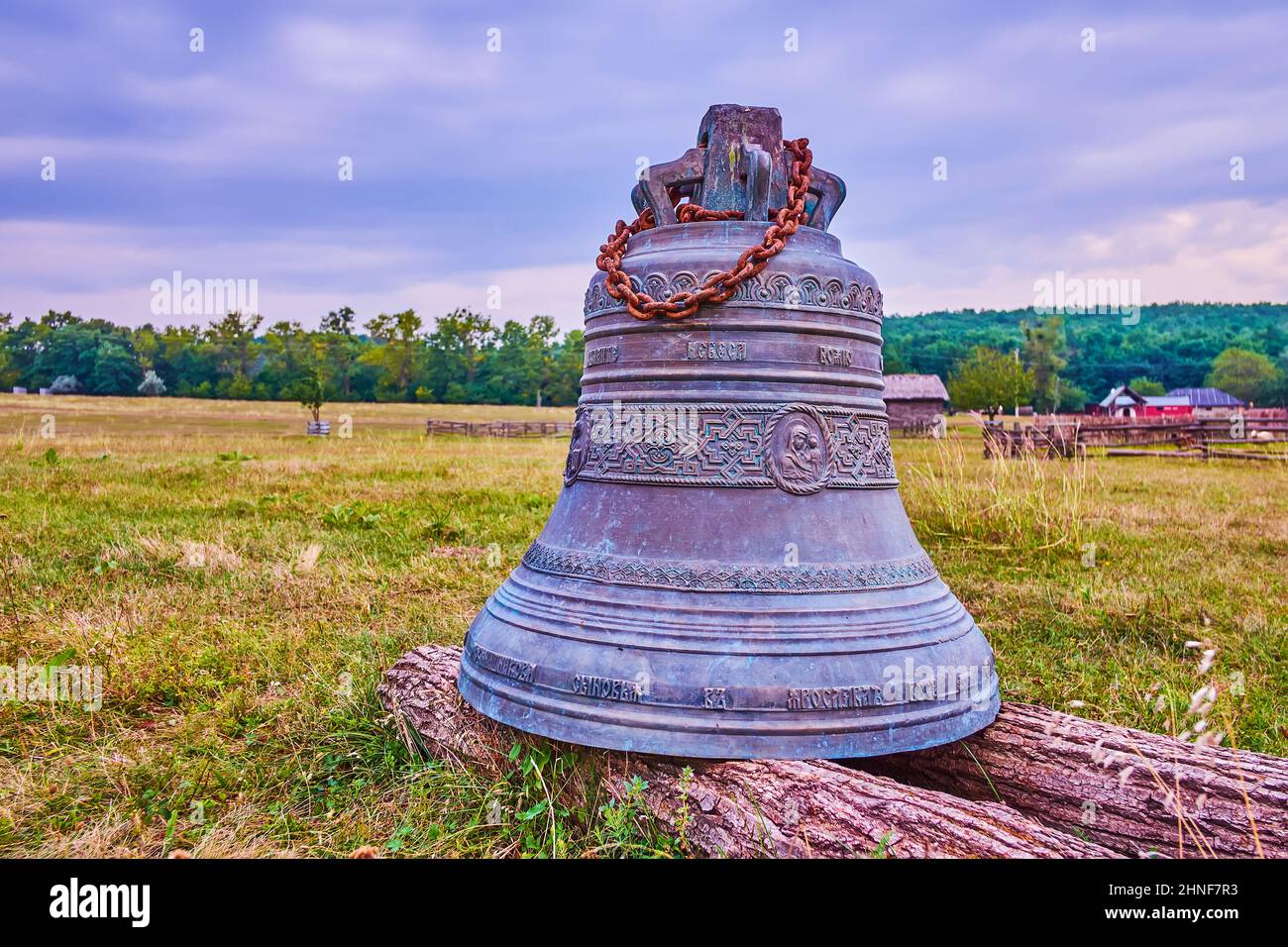 The bronze bell at St Nicholas church decorated with patterns and relief images of Virgin Mary, Cossack Village Scensen, Ukraine Stock Photo