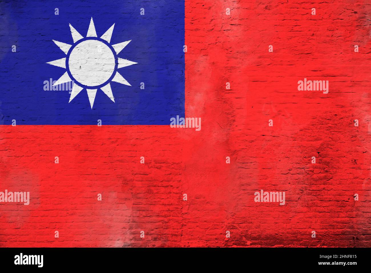 Full frame photo of a weathered flag of Taiwan (Republic of China (ROC)) painted on a plastered brick wall. Stock Photo