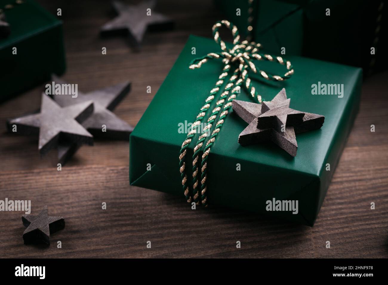 Christmas frame with green gift boxes and wooden star decorations on ...