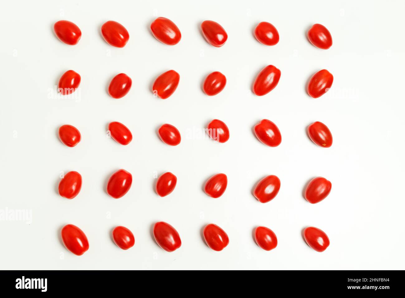 Tomatoes pattern on white background Cherry tomatoes, minimal concept Stock Photo