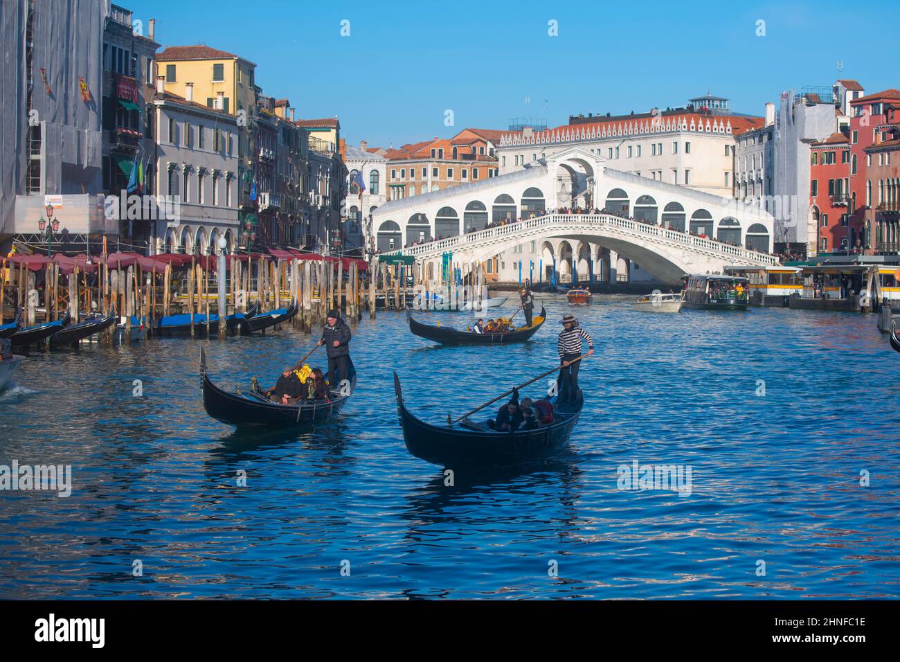 Gondolas and the Rialto Bridge on the Grand Canal, Venice Stock Photo