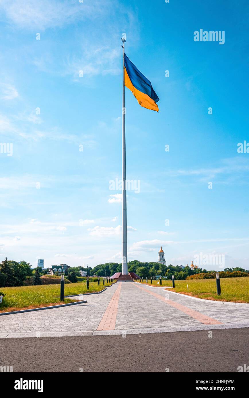 Bicolor blue and yellow national flag of ukraine waving in wind against sky Stock Photo