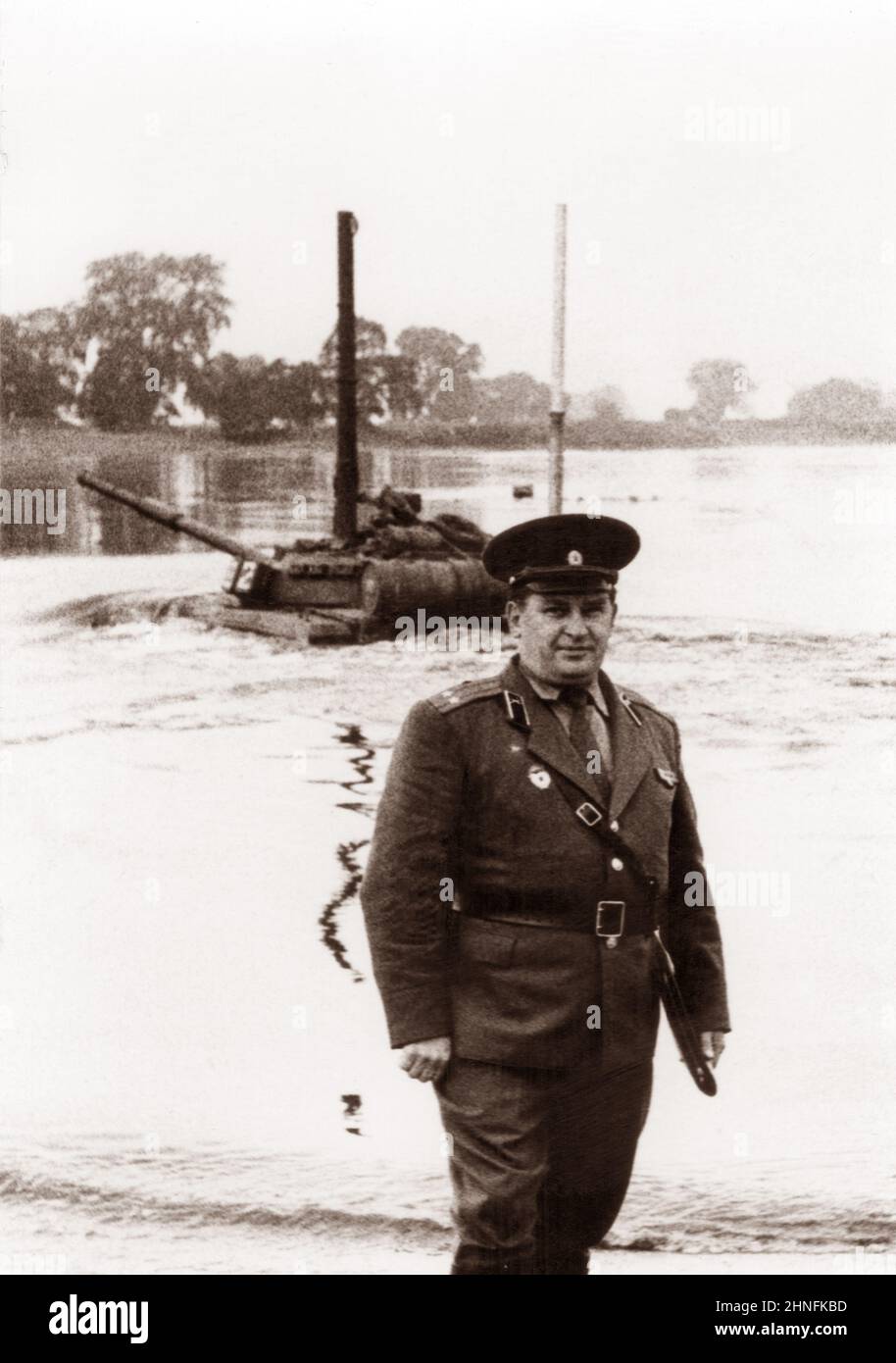 GDR - 09.25.1979: Photo of a lieutenant colonel of the Soviet army at military tank exercises. Tank T64 overcomes the water barrier. The tank rides al Stock Photo