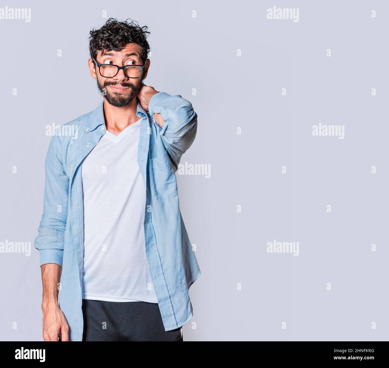 Latin young man with awkward face isolated on white background Concept Latin young man with awkward face isolated on white background Concept