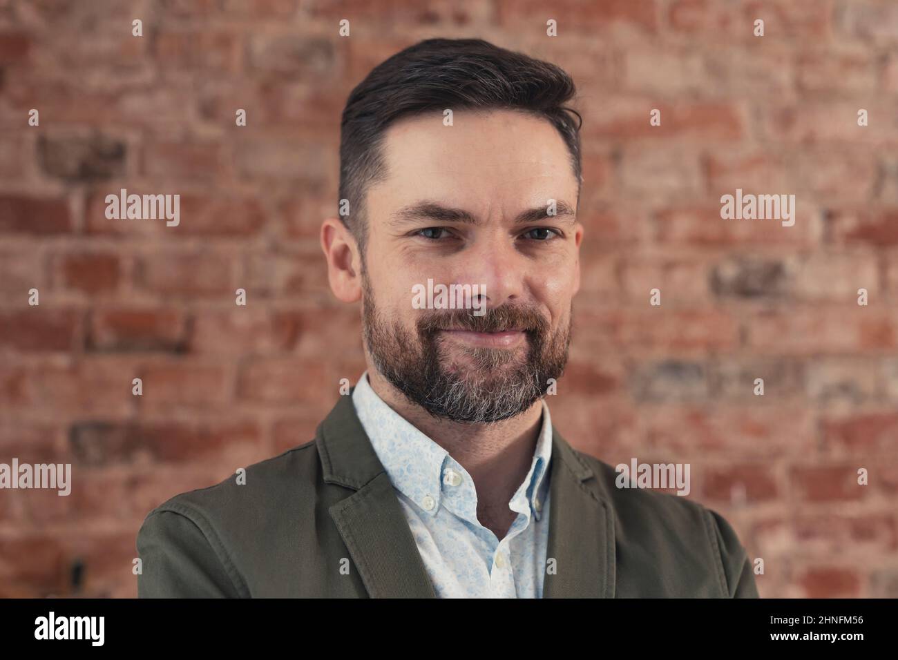 confident caucasian bearded businessman in a suit, smiling self-assured, medium close up shot. High quality photo Stock Photo