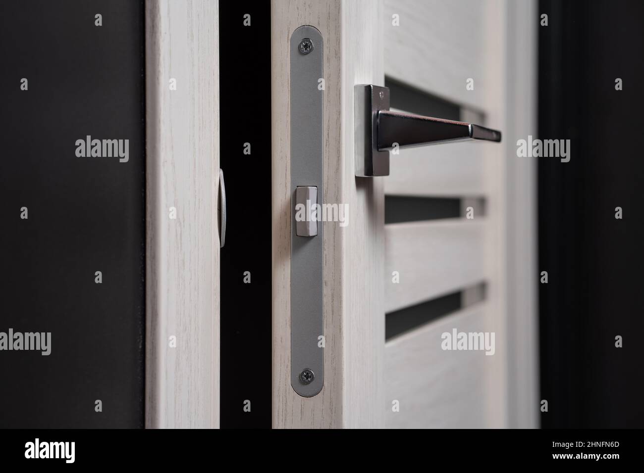 modern and secured metal door handle and latch detail Stock Photo Alamy