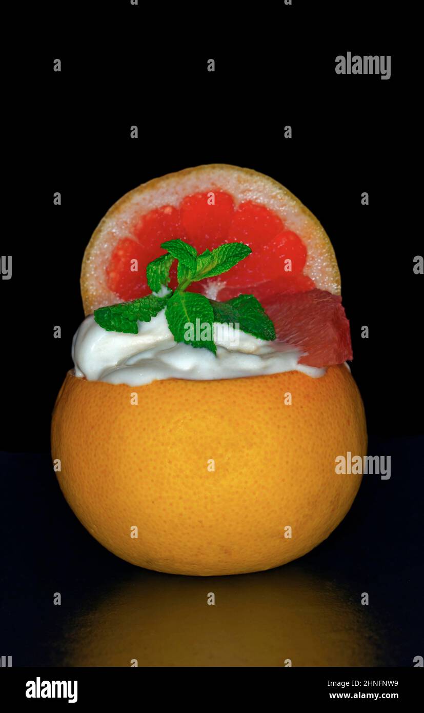 Grapefruit sorbet with fresh mint in the fruit, studio photography with