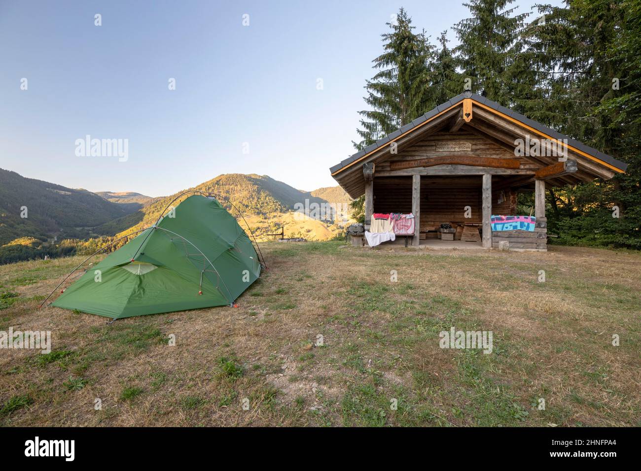 Green tent near hut on dry summer meadow, Praeg, Black Forest, Baden-Wuerrtemberg, Germany Stock Photo