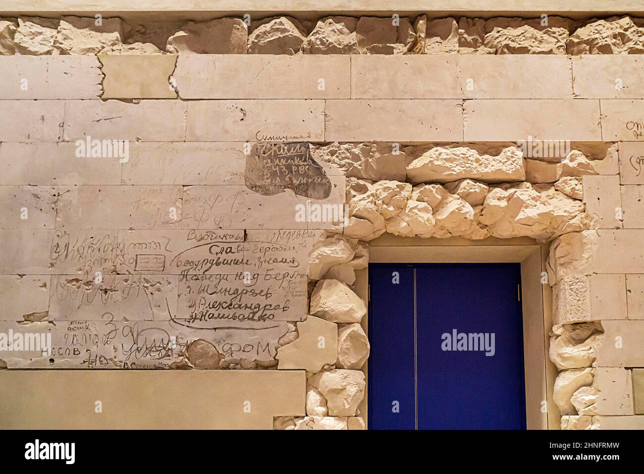Stone fragments of the 1945 Reichstag ruins reused with original Russian writing, Berlin, Germany Stock Photo