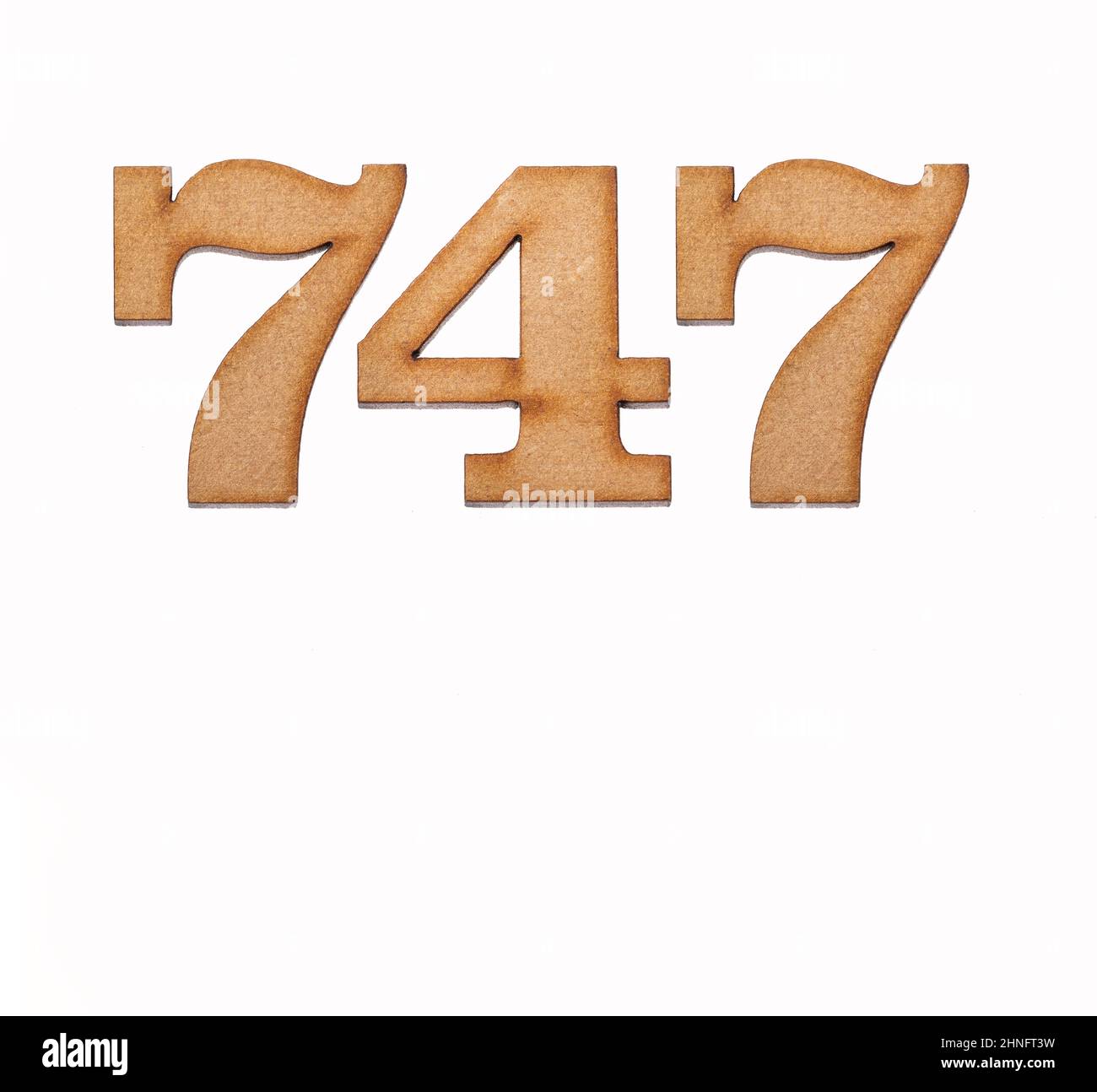 Number 747 in wood, isolated on white background Stock Photo - Alamy