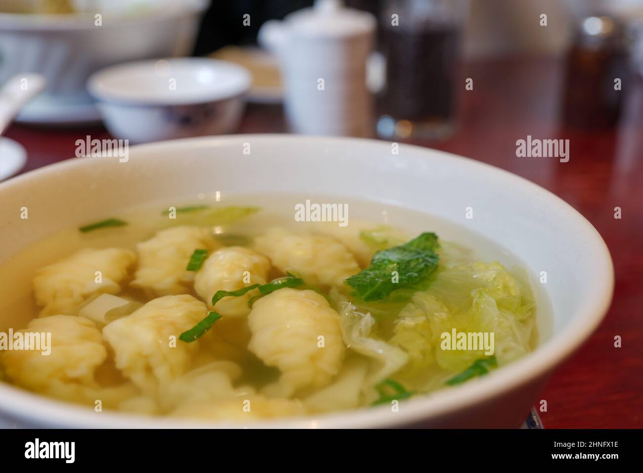Selective focus at dumpling on wonton hot Chinese soup. Stock Photo