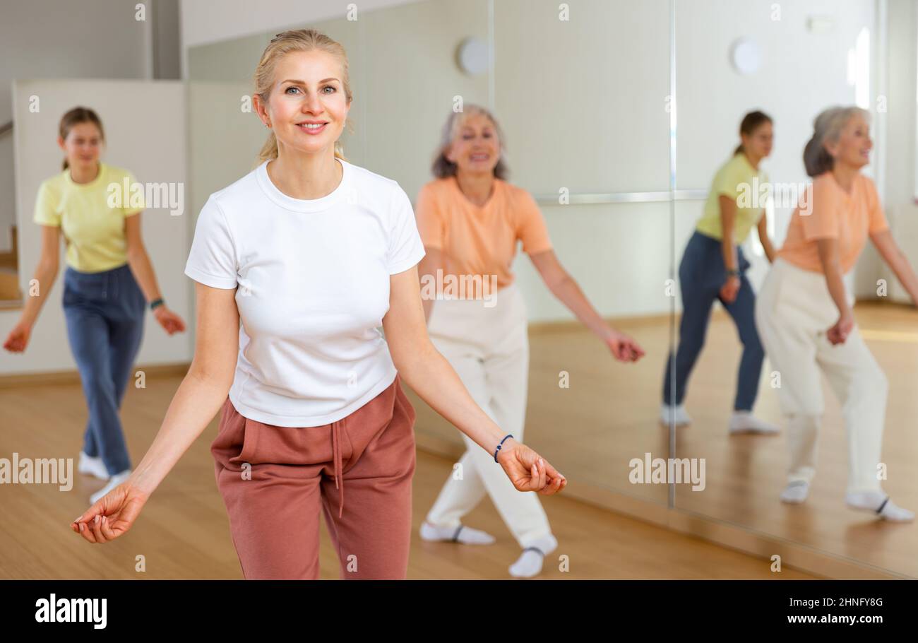 Woman performing jazz style dance during group training Stock Photo