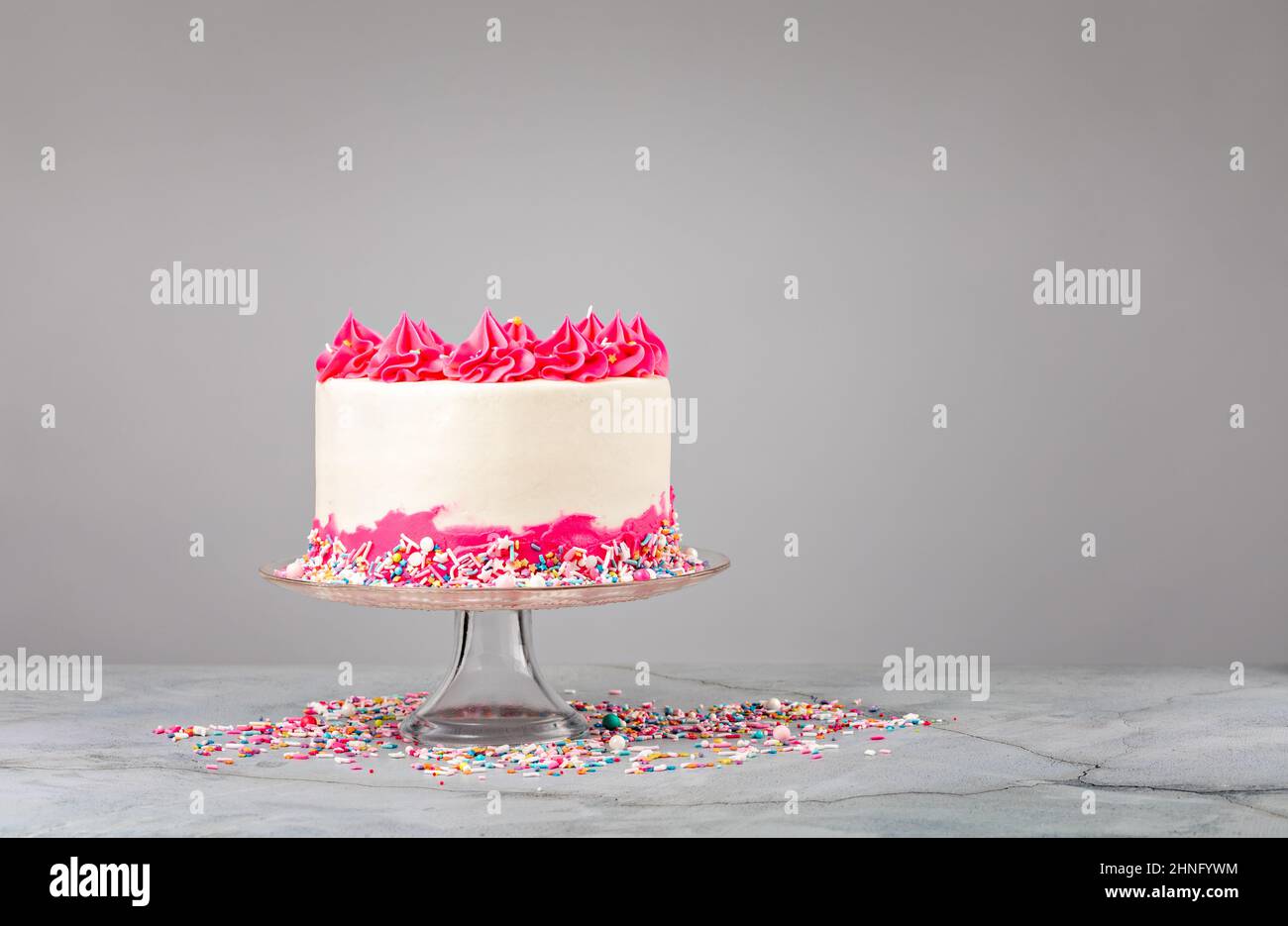 Pink Birthday Cake with buttercream icing and sprinkles Stock Photo - Alamy