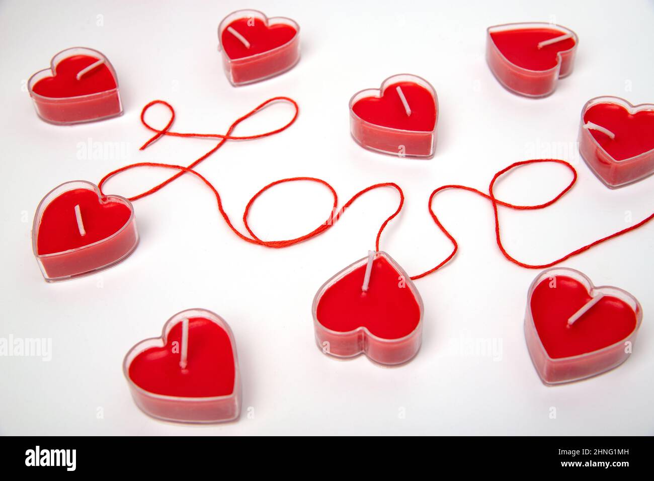 Text love and red candle hearts around the word. Romance. February 14 Valentine's Day Stock Photo