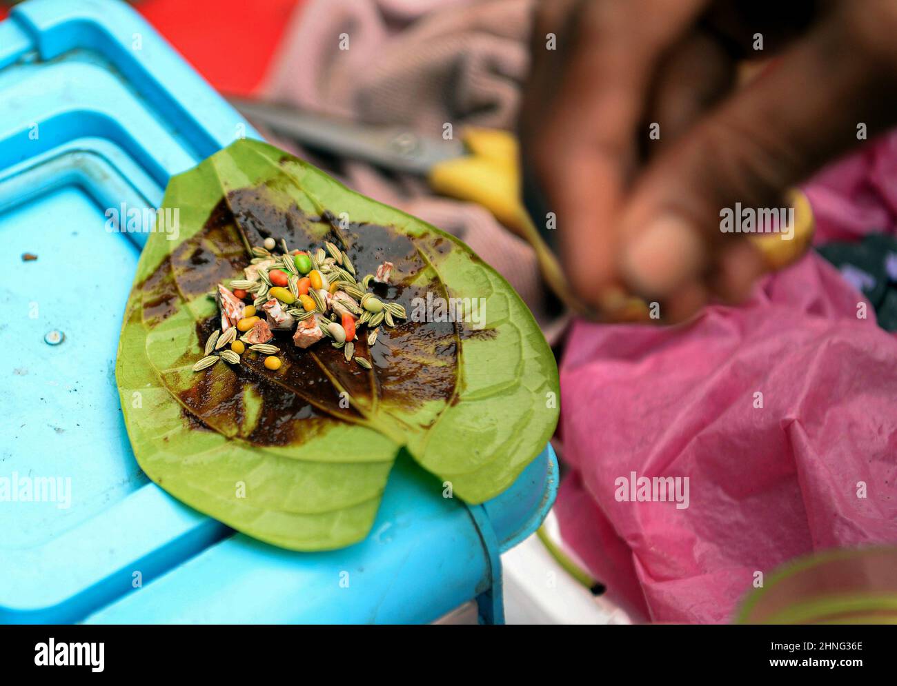 Bangkok, Thailand. 16th Feb, 2022. A close-up of a meetha paan, made of betel leaves filled with a range of sweet jam-like spreads and crunchy titbits like tutti-frutti, cherries, chopped dates, filled with chopped betel (areca) nut (Areca catechu) and slaked lime (chuna; calcium hydroxide) in Little India, Phahurat Market.The area is a 5 minutes walk from Bangkok's Chinatown and boasts the economy of a large northwestern Sikh community. Credit: SOPA Images Limited/Alamy Live News Stock Photo