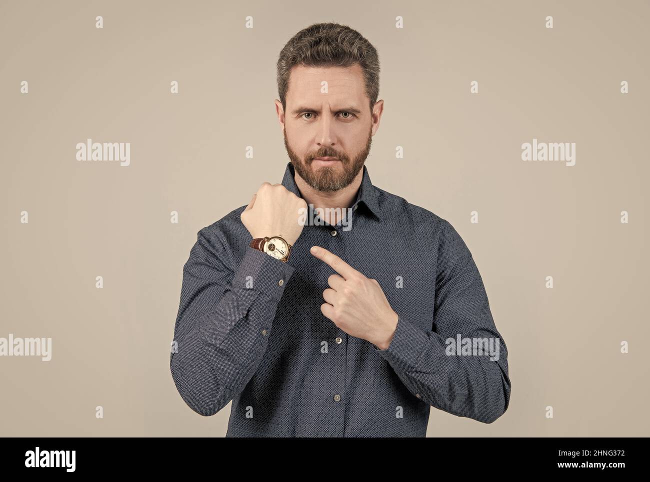 The elegance of punctuality. Bearded man point at wristwatch. Punctuality concept. Business time Stock Photo