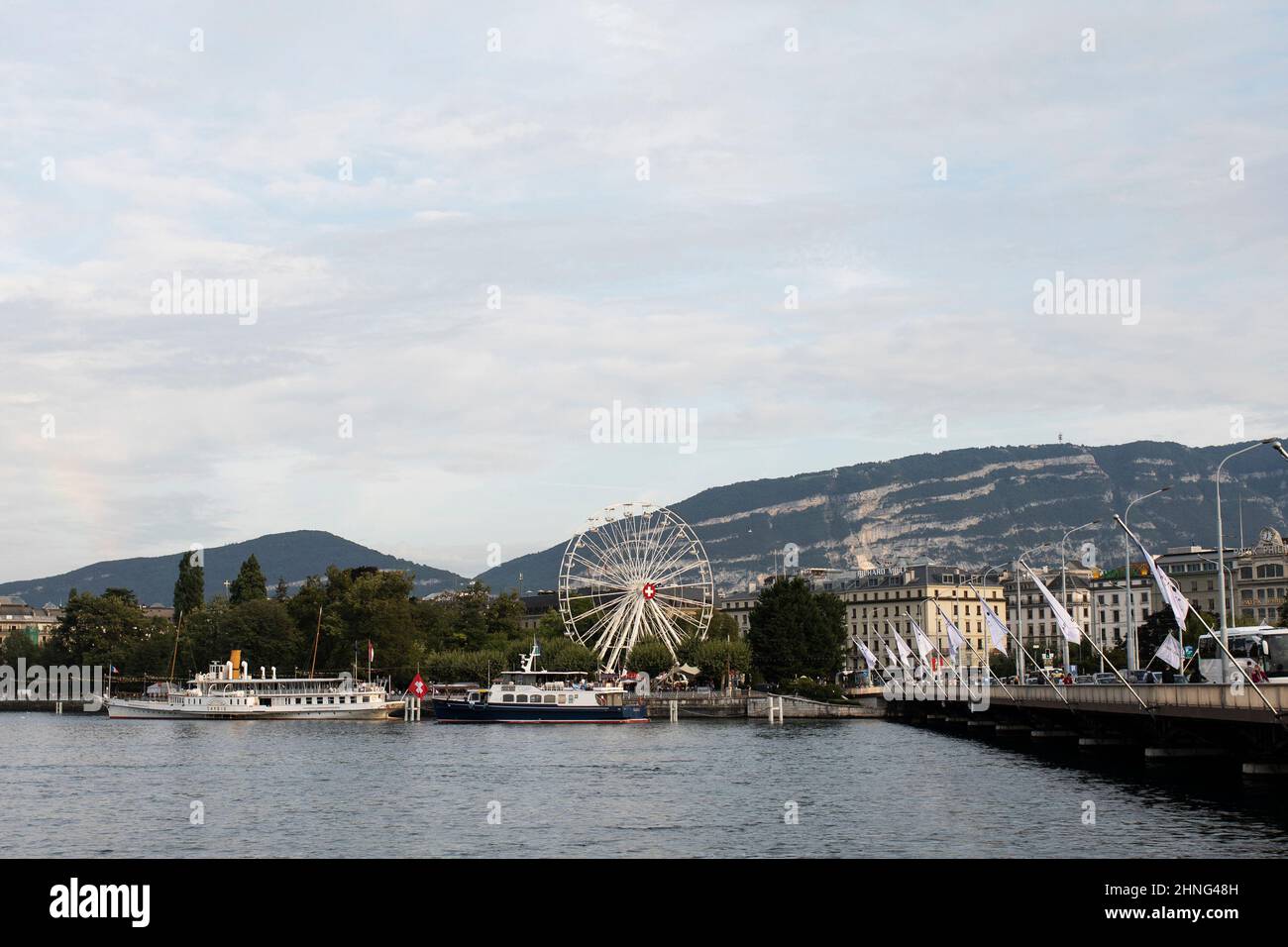 Looking across Lake Geneva (Lac Leman) toward the Jardin Anglais, Prom du Lac, and Pont du Mont-Blanc on a summer day in Geneva, Switzerland. Stock Photo