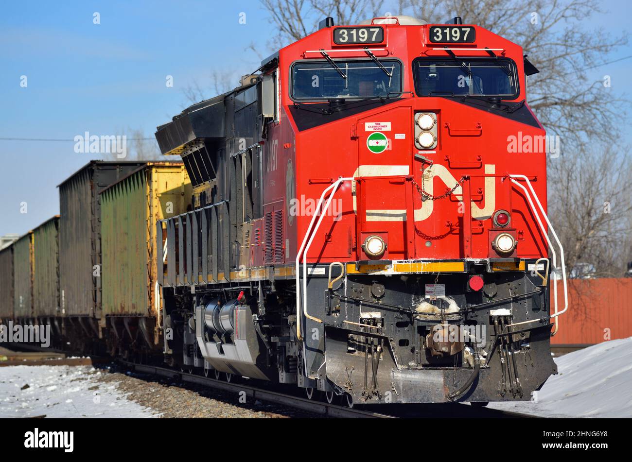 Elgin, Illinois, USA. A single Canadian National Railway locomotive leads a freight train through Spaulding Junction. Stock Photo