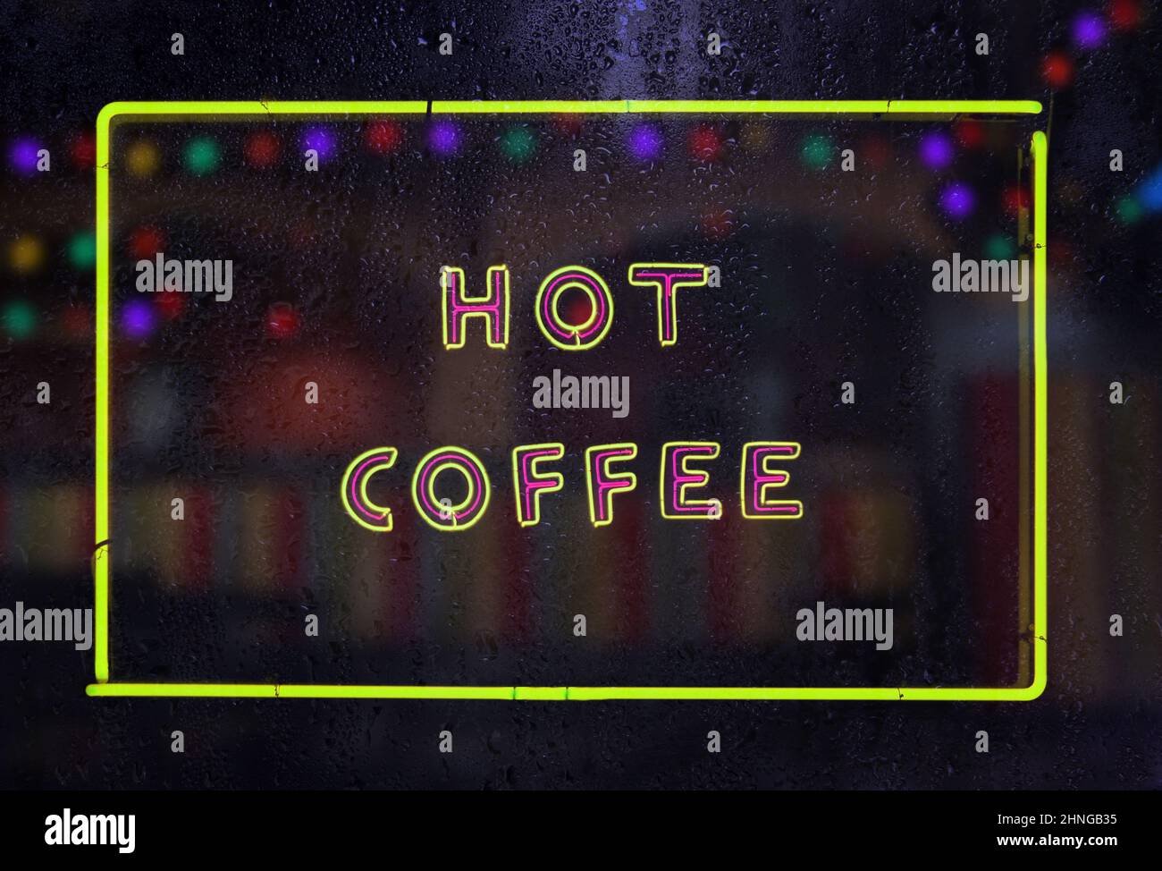 Vintage Neon Hot Coffee Sign in Rainy Window Stock Photo