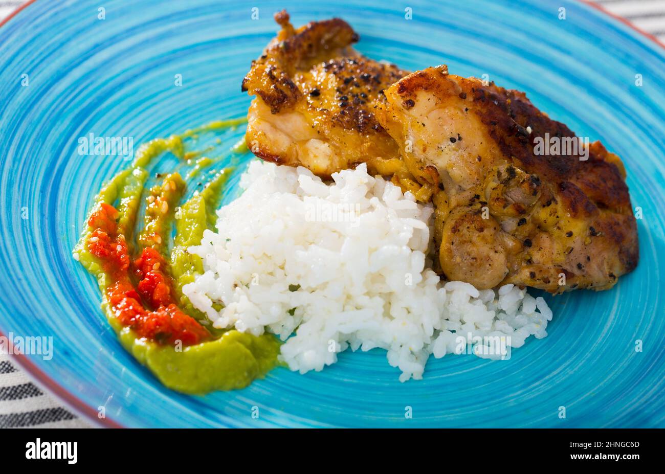 Fried Chicken Thighs With White Rice And Sauces Stock Photo Alamy fried-chicken-thighs-with-white-rice-and-sauces-stock-photo-alamy