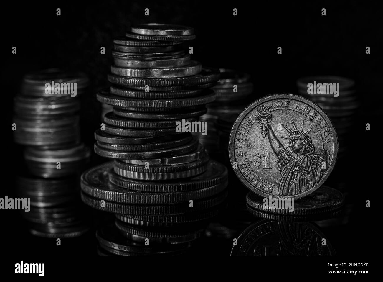 Stacks of Coins One Dollar Coin Blurred Background Dramatic Light Black and White Stock Photo