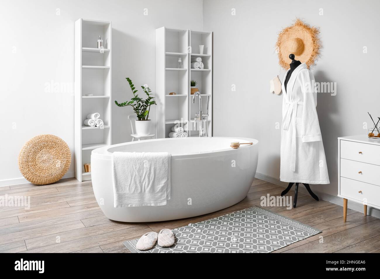 Interior of light bathroom with shelving units and mannequin Stock