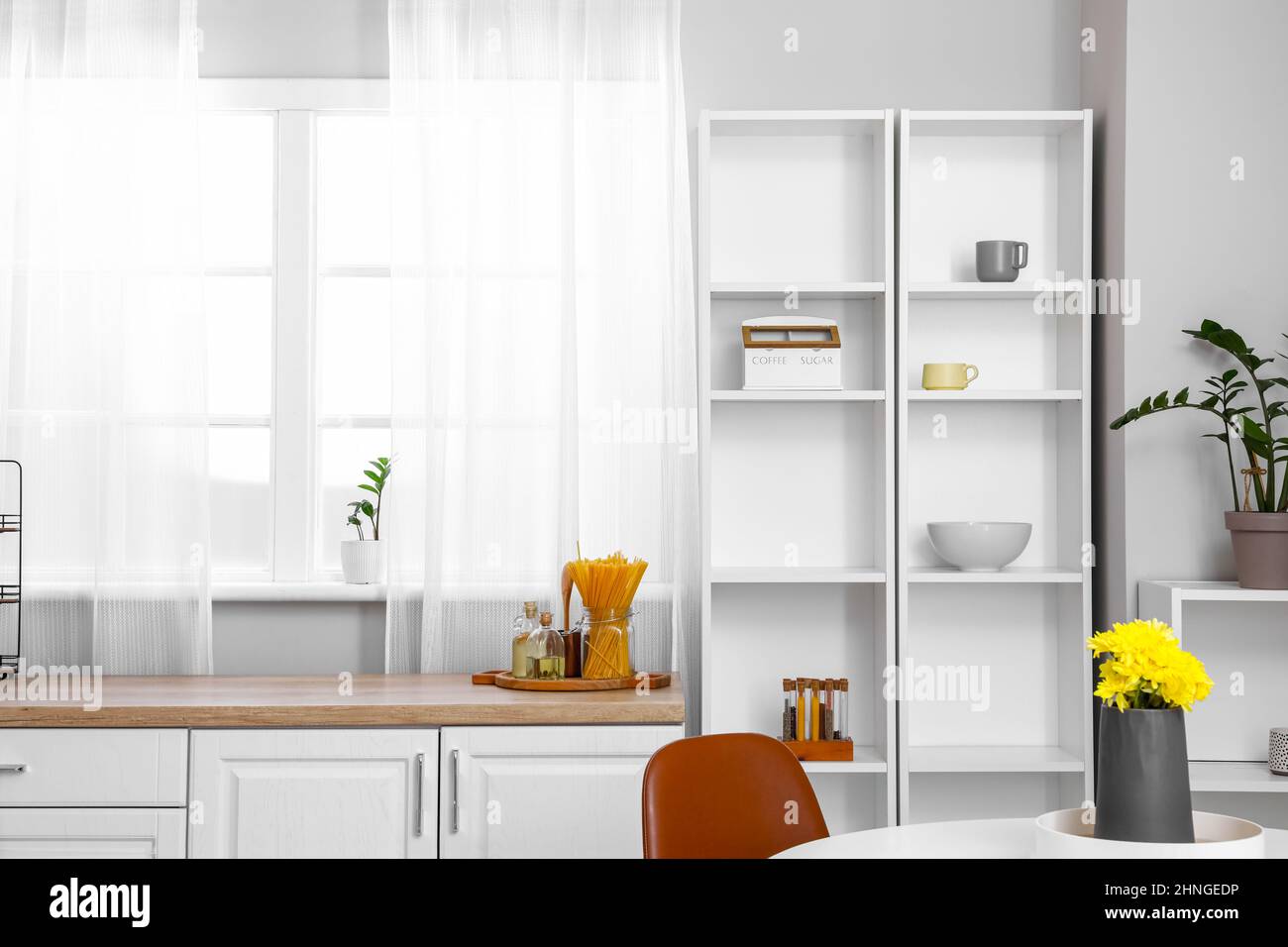 Interior of light kitchen with white shelving unit Stock Photo - Alamy