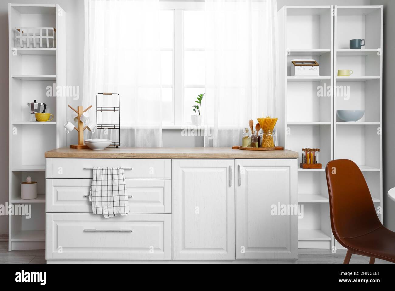 Interior of light kitchen with white shelving units Stock Photo - Alamy