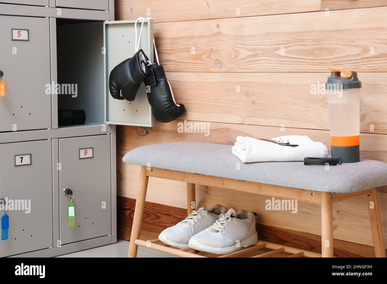 Locker with sport equipment and bench in changeroom Stock Photo Alamy