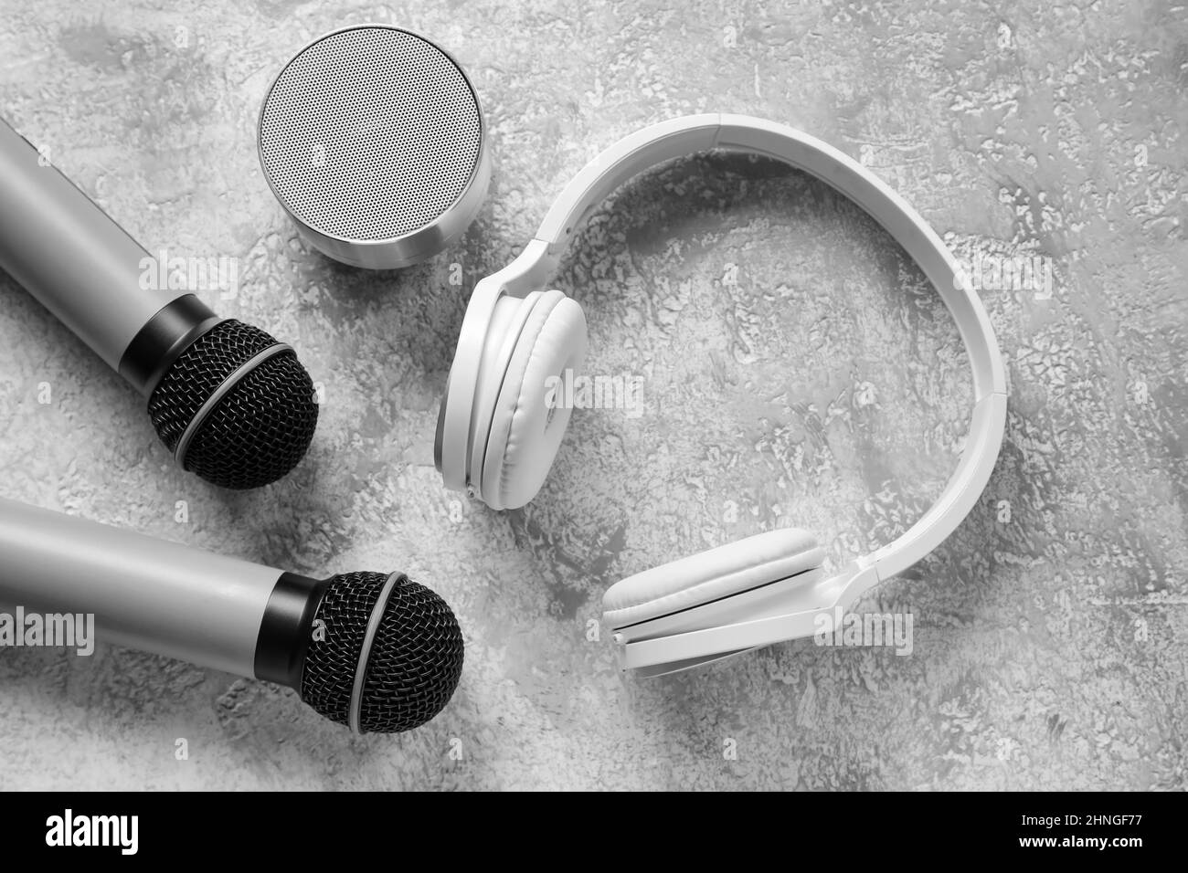Wireless portable speaker, microphones and headphones on grunge background Stock Photo