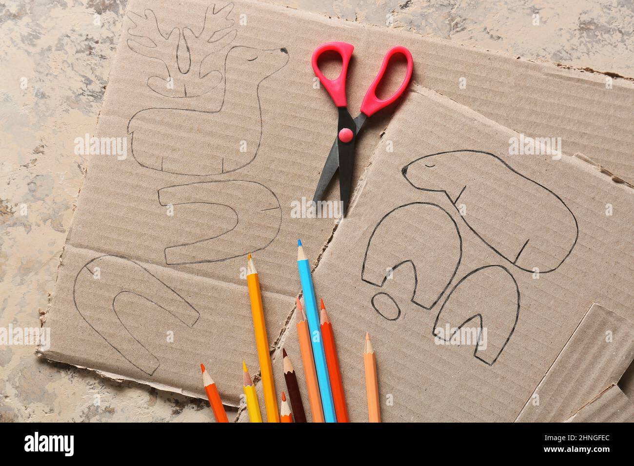 Stationery supplies for handcraft and cardboard toy drawings on grunge