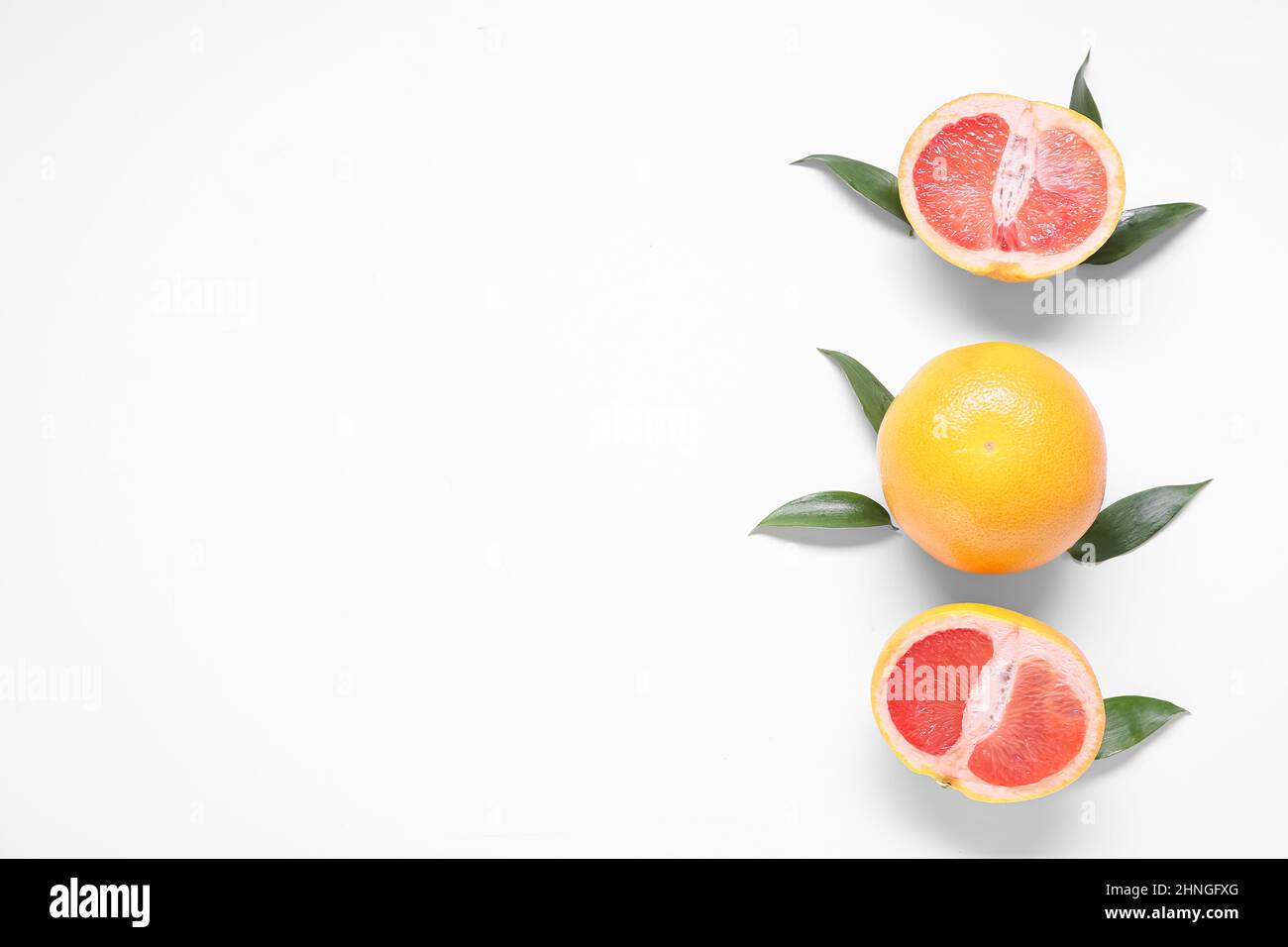 Delicious grapefruits on white background Stock Photo