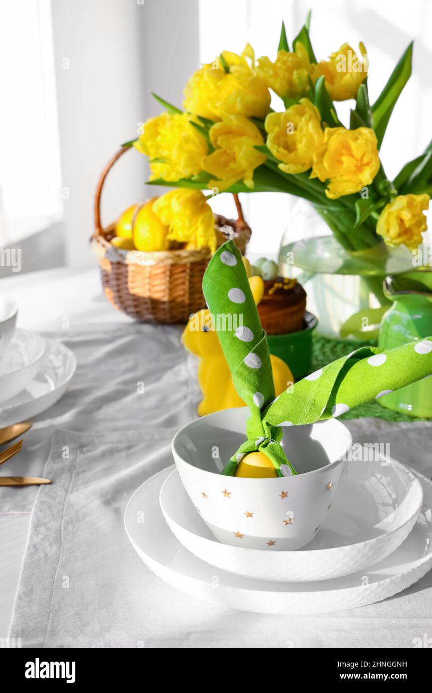 Stylish setting for Easter celebration on dining table Stock Photo
