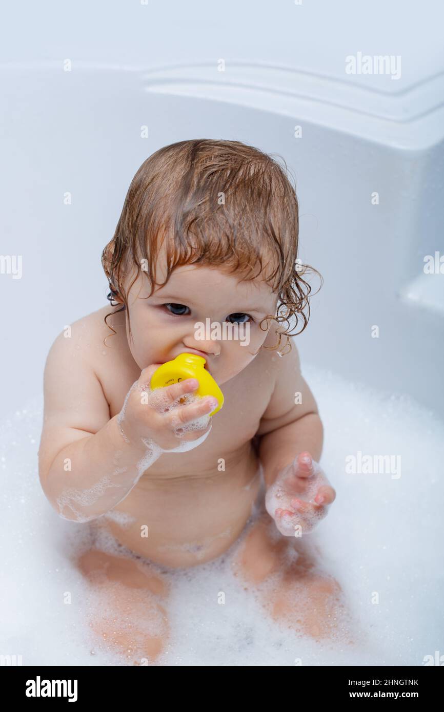 Todler in shower, funny infant in shower. Baby showering. Portrait of