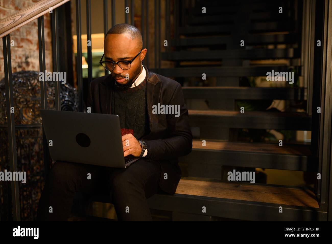 a black man works at a laptop close-up of his face. video conferences Stock Photo