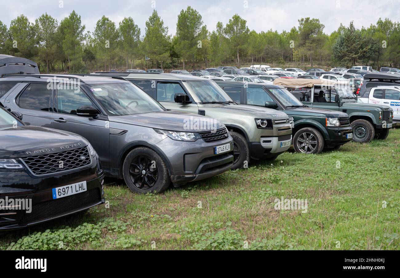 Shot of the set of the modern Land Rovers parked in the field in Suria, Spain Stock Photo