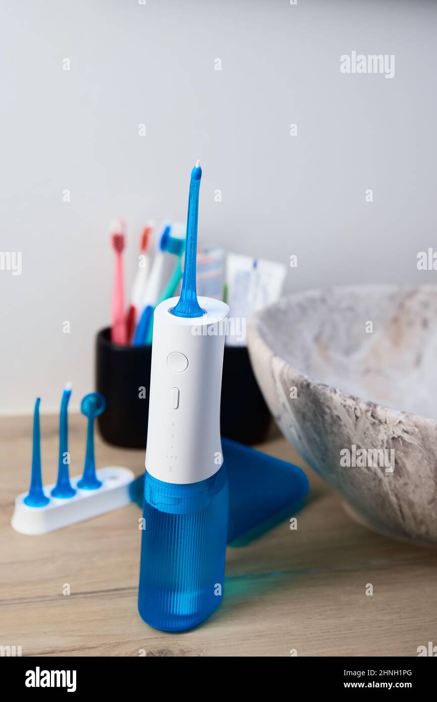 Blue home oral irrigator kit in bathroom, Waterpik for teeth cleaning,  portable water flosser for dental care Stock Photo - Alamy