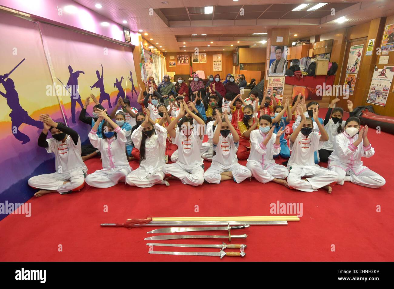 Dhaka. 17th Feb, 2022. Wushu students applause as they watch the