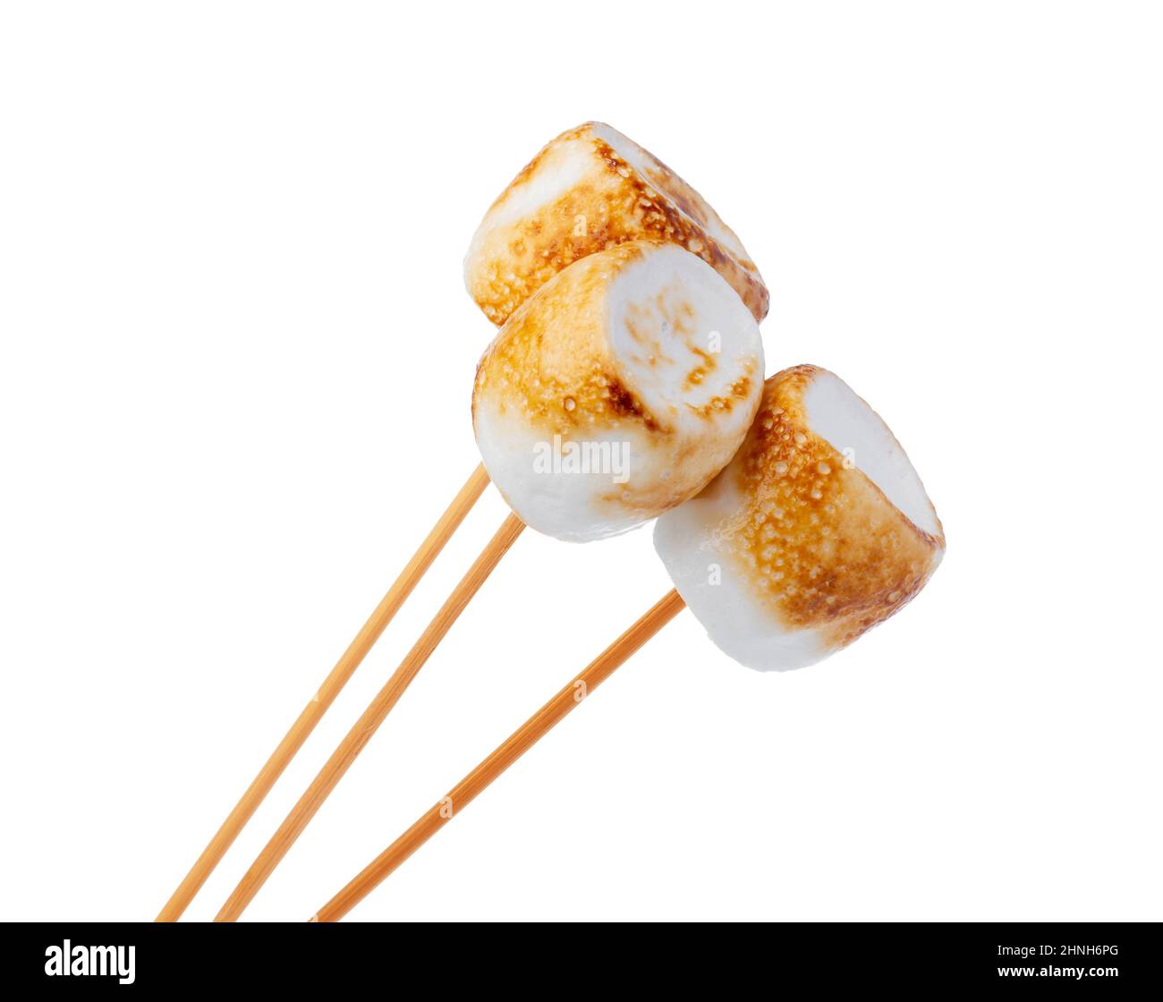 Grilled marshmallows on sticks isolated on white Stock Photo