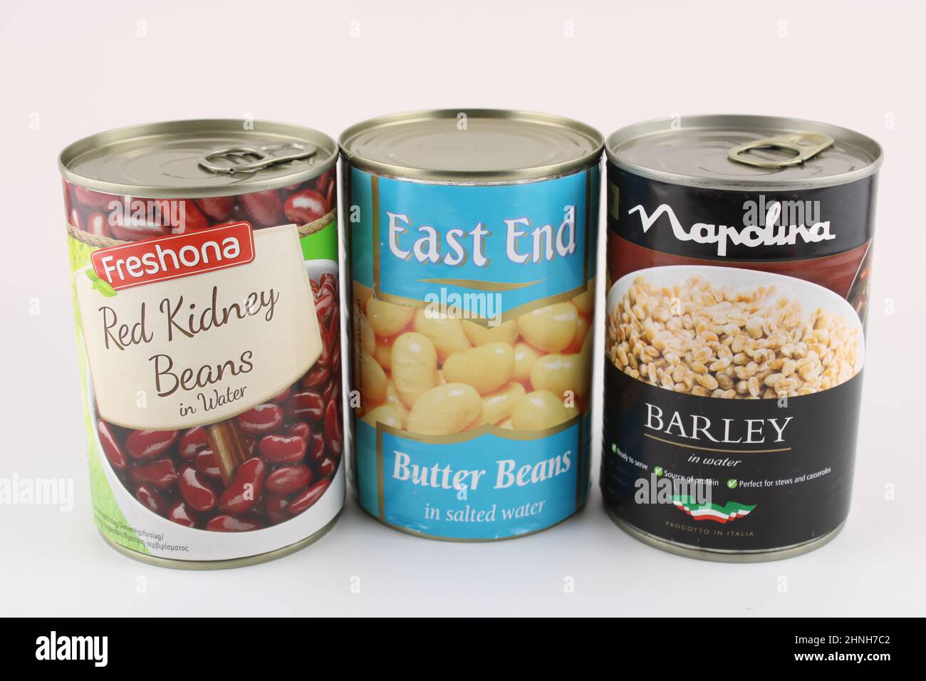 Tins of kidney beans, butter beans and barley isolated on white with copy space. Stock Photo