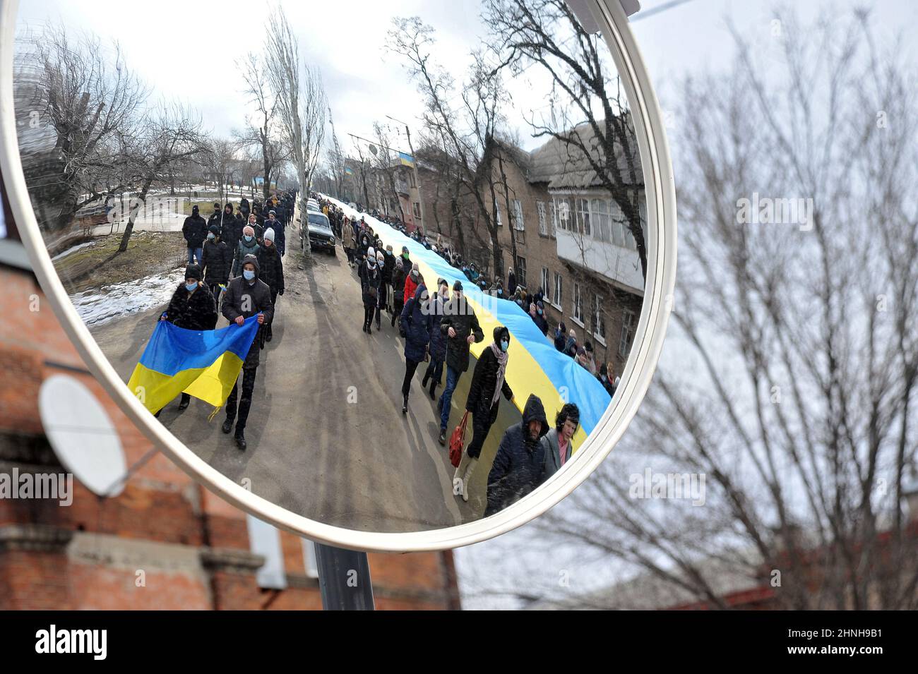 UKRAINE FEBRUARY 16, 2022 People carrying a long