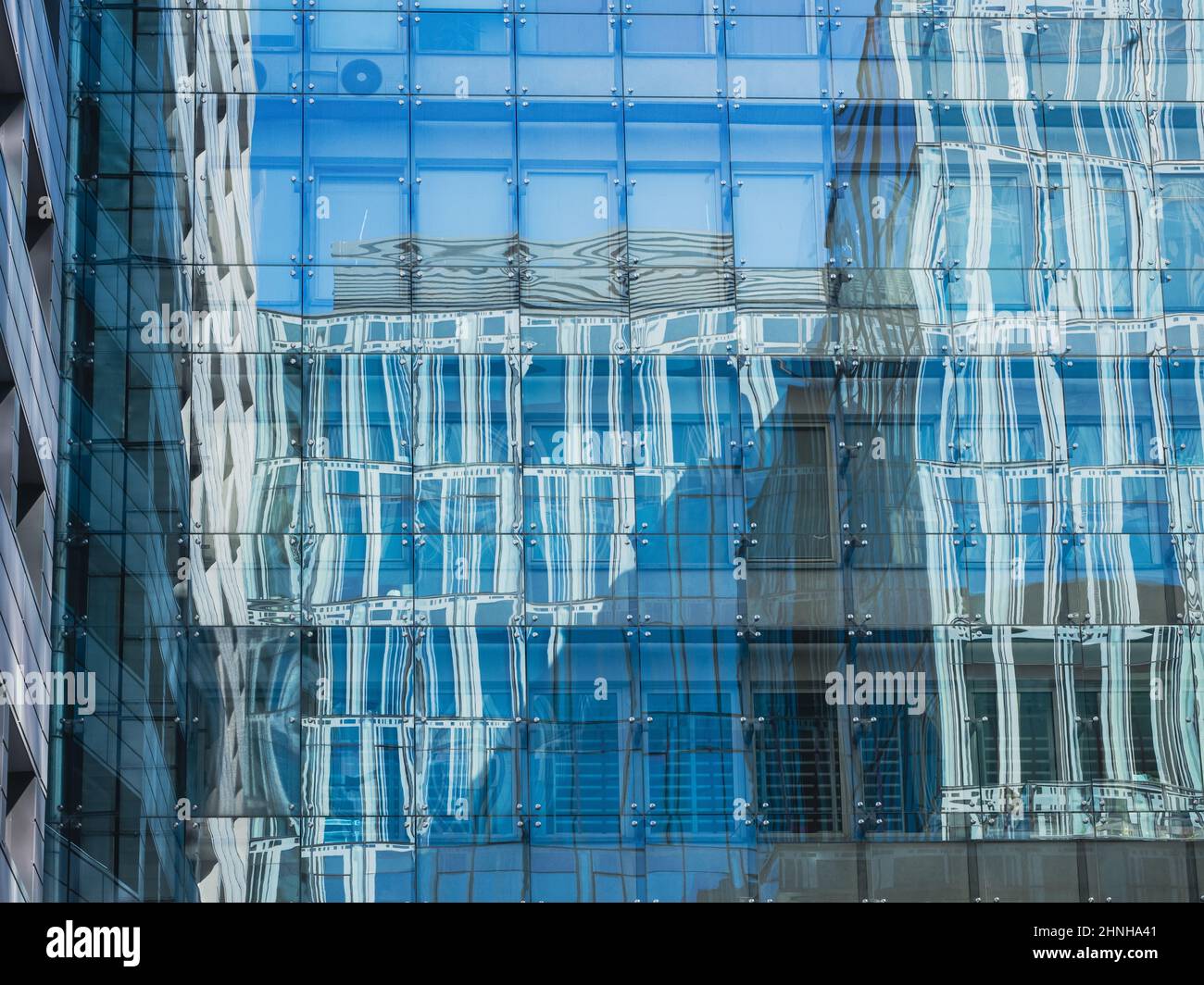 modern glass building mirror reflections. front view of modern glass