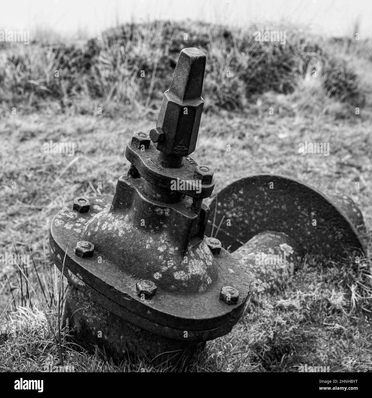 An old sluice gate valve lies discarded next to the Devonport Leat. Stock Photo