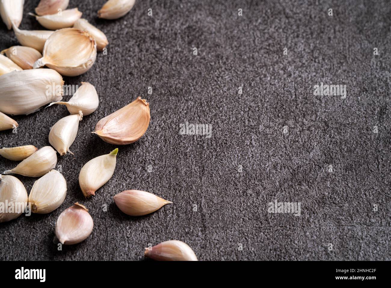 Close up of fresh garlic cloves on black table background Stock Photo ...