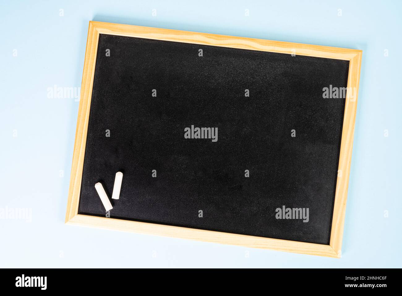 a blank black chalkboard on a white surface Stock Photo